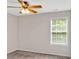 Neutral bedroom with a ceiling fan and a window overlooking a green landscape at 57 Craig Meadows Ln, Douglasville, GA 30134
