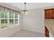 Bright breakfast nook with a window overlooking the yard, features a chandelier and neutral finishes at 57 Craig Meadows Ln, Douglasville, GA 30134