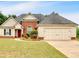 Charming single-Gathering home with brick and vinyl siding, complemented by a well-manicured lawn and mature landscaping at 57 Craig Meadows Ln, Douglasville, GA 30134