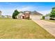 Expansive front lawn showcasing a charming one-story home with a two-car garage and traditional architectural details at 57 Craig Meadows Ln, Douglasville, GA 30134