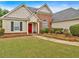 Inviting front yard with lush landscaping leads to a well-maintained home with a bright red front door at 57 Craig Meadows Ln, Douglasville, GA 30134
