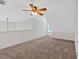 Spacious loft area with neutral carpet and ceiling fan at 57 Craig Meadows Ln, Douglasville, GA 30134