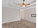 Spacious main bedroom with carpet flooring, tray ceiling, ceiling fan, and natural light at 57 Craig Meadows Ln, Douglasville, GA 30134