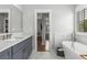 Bright bathroom with a freestanding tub and view to the hall at 111 Brighton Blvd, Woodstock, GA 30188