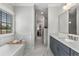 Elegant bathroom featuring a soaking tub, marble floors, and a double vanity at 111 Brighton Blvd, Woodstock, GA 30188