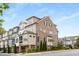 Charming brick townhome featuring manicured landscaping, attached garages, and multiple stories of comfortable living at 111 Brighton Blvd, Woodstock, GA 30188