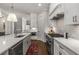 Modern white kitchen features stainless steel appliances and white subway tile at 111 Brighton Blvd, Woodstock, GA 30188