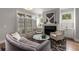 Elegant living room featuring a fireplace, plantation shutters, and stylish furnishings at 111 Brighton Blvd, Woodstock, GA 30188