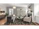 Well-appointed living room with fireplace, plantation shutters, and seamless flow into the dining space at 111 Brighton Blvd, Woodstock, GA 30188