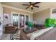 Relaxing covered patio with ample seating and a glass-top coffee table at 111 Brighton Blvd, Woodstock, GA 30188