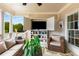 Covered patio with comfortable wicker furniture and built-in shelving and television at 111 Brighton Blvd, Woodstock, GA 30188