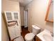 Compact bathroom with a toilet, sink, and cabinet for storage at 169 Concorde Dr, Villa Rica, GA 30180
