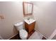 Simple bathroom featuring a toilet and a vanity with a wood-framed mirror at 169 Concorde Dr, Villa Rica, GA 30180