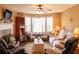 Cozy living room featuring a fireplace, ceiling fan, and natural light from the windows at 169 Concorde Dr, Villa Rica, GA 30180