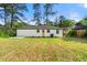 Large backyard featuring a lawn and a white house with a black trim and an orange door at 2146 Trailwood Rd, Decatur, GA 30032