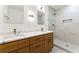 Modern bathroom features double vanity, marble countertops, stylish lighting and elegant tiled walk-in shower at 2146 Trailwood Rd, Decatur, GA 30032