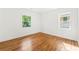 A bright and airy bedroom featuring gleaming hardwood floors and two large windows at 2146 Trailwood Rd, Decatur, GA 30032