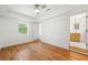 Spacious bedroom with hardwood floors, ceiling fan, and a doorway leading to an en-suite bathroom at 2146 Trailwood Rd, Decatur, GA 30032