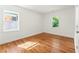 Bright bedroom featuring hardwood floors and ample natural light from the two windows at 2146 Trailwood Rd, Decatur, GA 30032