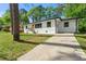 Freshly painted white brick home with a neatly kept lawn and a convenient concrete driveway at 2146 Trailwood Rd, Decatur, GA 30032