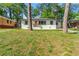 Charming white brick home with a well-maintained lawn and an inviting orange front door at 2146 Trailwood Rd, Decatur, GA 30032
