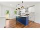 Bright kitchen featuring a blue island with pendant lights, stainless appliances, and white cabinetry at 2146 Trailwood Rd, Decatur, GA 30032