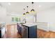 Kitchen island with a farmhouse sink, stainless steel dishwasher, and pendant lighting at 2146 Trailwood Rd, Decatur, GA 30032