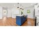 Modern kitchen featuring a blue island, farmhouse sink, stainless appliances, and hardwood floors at 2146 Trailwood Rd, Decatur, GA 30032