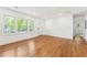 Bright living room with hardwood floors, large windows, and freshly painted white walls at 2146 Trailwood Rd, Decatur, GA 30032