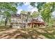Rear view of home with a stone foundation, deck, and walkout basement at 4336 Yancey Rd, Douglasville, GA 30135