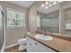 Well-lit bathroom featuring a granite vanity, sink, and shower-tub combo, complemented by a large window at 4336 Yancey Rd, Douglasville, GA 30135