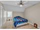 Bedroom features a ceiling fan, closet, and large window at 4336 Yancey Rd, Douglasville, GA 30135
