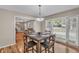 Dining area with a square table, four chairs, and a bay window overlooking the yard at 4336 Yancey Rd, Douglasville, GA 30135
