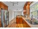 Spacious kitchen featuring wood floors, stainless steel appliances, and views of the yard at 4336 Yancey Rd, Douglasville, GA 30135
