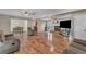 Open-concept living room with hardwood floors, fireplace, and dining area at 4336 Yancey Rd, Douglasville, GA 30135