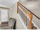 Carpeted staircase with white risers and a stained wood handrail leading to the upper level of the home at 4336 Yancey Rd, Douglasville, GA 30135