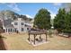 Expansive backyard with a pergola covered seating area, mature trees, and a neatly fenced perimeter at 5241 Marston Rd, Atlanta, GA 30360