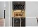 Wet bar featuring wine cooler, wine rack, glassware storage, and countertop at 5241 Marston Rd, Atlanta, GA 30360