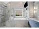Marble bathroom featuring a walk-in shower, soaking tub, and built-in shelving at 5241 Marston Rd, Atlanta, GA 30360