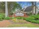 An entrance sign to Mayfair Park is surrounded by lush greenery and flowering plants at 5241 Marston Rd, Atlanta, GA 30360