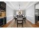 Formal dining room with hardwood floors, coffered ceilings, and a stylish floral centerpiece at 5241 Marston Rd, Atlanta, GA 30360