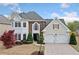Charming home with stone accents, manicured landscaping, and a two-car garage at 5241 Marston Rd, Atlanta, GA 30360