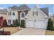 Charming two-story home with a two-car garage, landscaped front yard, and a combination of stucco and stone facade at 5241 Marston Rd, Atlanta, GA 30360