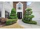 Elegant front entrance with manicured landscaping, a stone facade, and decorative double front doors at 5241 Marston Rd, Atlanta, GA 30360