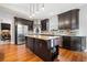 Spacious kitchen with dark cabinetry, stainless steel appliances, a central island, and hardwood flooring at 5241 Marston Rd, Atlanta, GA 30360