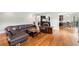 Open floor plan featuring hardwood floors, kitchen and dining area in view, and leather furniture at 5241 Marston Rd, Atlanta, GA 30360
