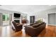 Cozy living room with hardwood floors, a fireplace, large windows, and comfortable leather furniture at 5241 Marston Rd, Atlanta, GA 30360