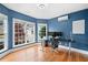 Well-lit home office featuring large windows, a modern desk, and hardwood floors at 5241 Marston Rd, Atlanta, GA 30360