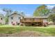 Home's backyard with a spacious deck, lush lawn, and mature trees at 5286 Westhill Dr, Norcross, GA 30071