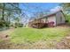 This backyard includes a deck, green grass and landscaping at 5286 Westhill Dr, Norcross, GA 30071